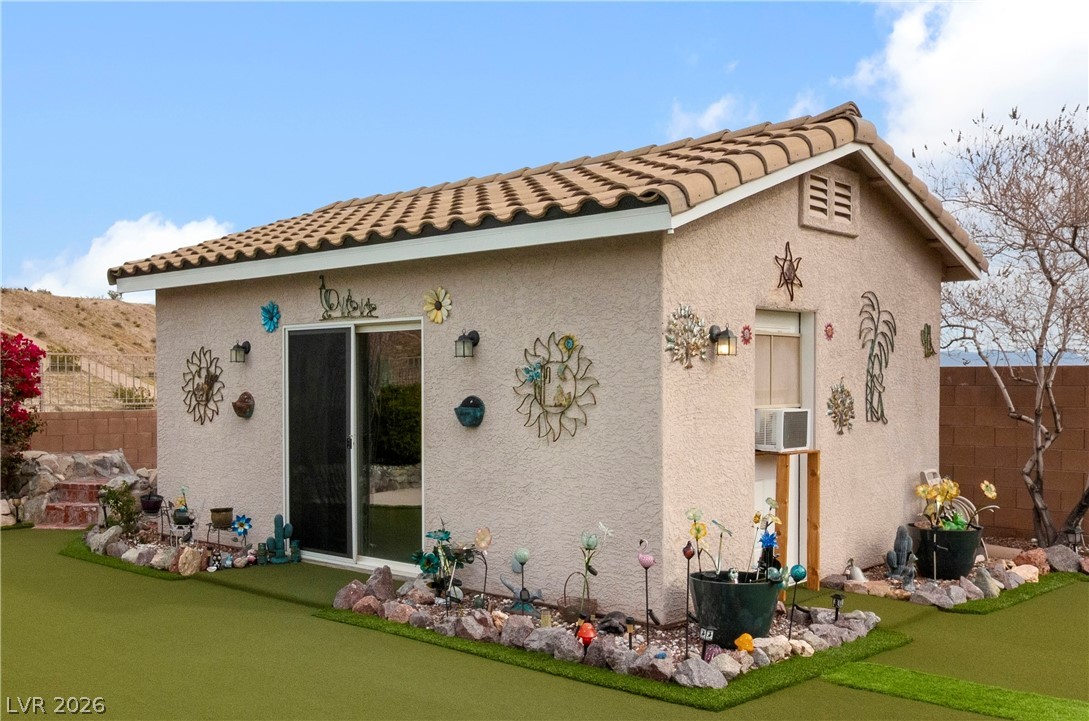 2516 Morrow Ridge Place Laughlin, NV 89029 - Photo 38 of 93 Casita / Guest Quarters located in the backyard featuring stucco siding, a tile roof, an area to practice putting, and cooling unit