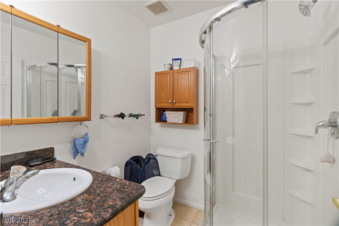 2516 Morrow Ridge Place Laughlin, NV 89029 - Photo 45 of 93 Casita / Guest Quarters Full Bathroom featuring vanity, a shower stall, and light tile patterned floors