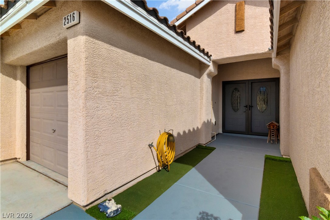 2516 Morrow Ridge Place Laughlin, NV 89029 - Photo 5 of 93 View of exterior entry featuring stucco siding and a tiled roof