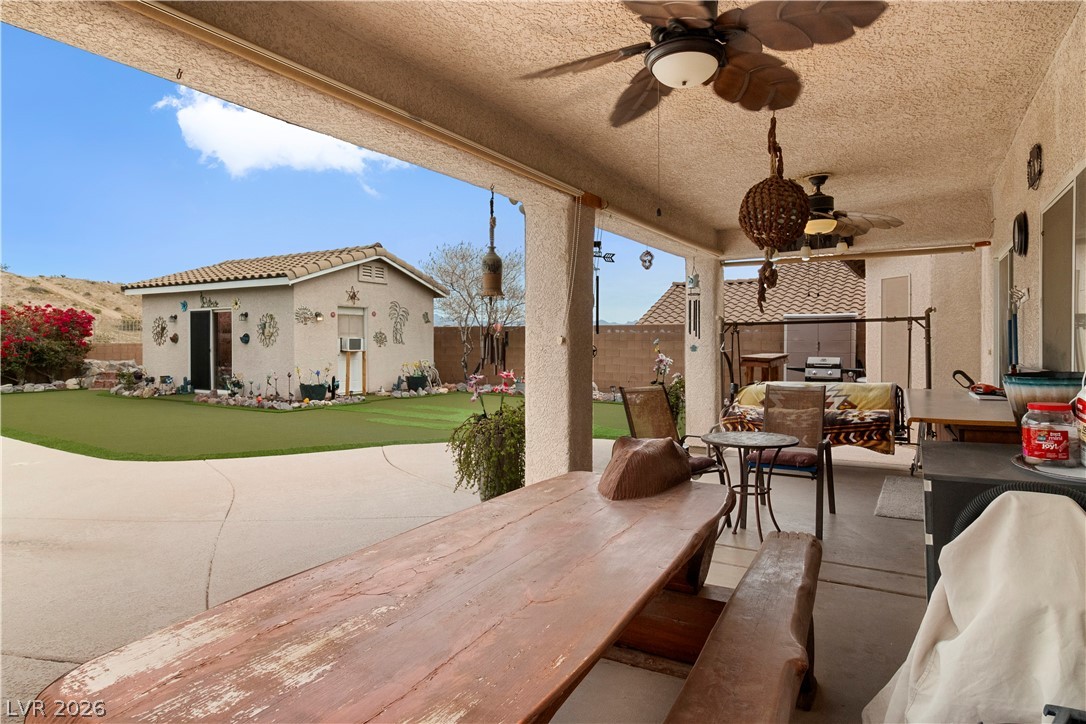 2516 Morrow Ridge Place Laughlin, NV 89029 - Photo 55 of 93 Fenced backyard featuring a putting area, ceiling fan, a patio area, and an outdoor structure