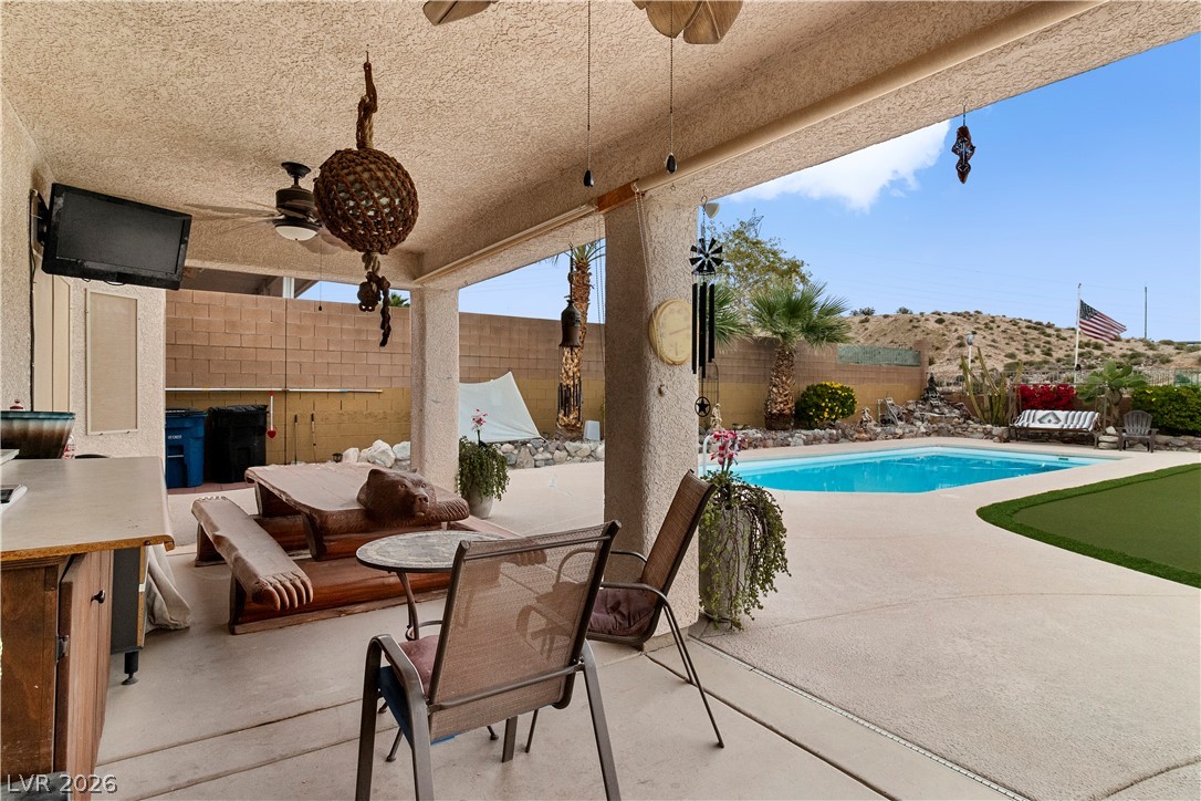 2516 Morrow Ridge Place Laughlin, NV 89029 - Photo 56 of 93 View of patio with pool in background, a fenced backyard, and outdoor seating