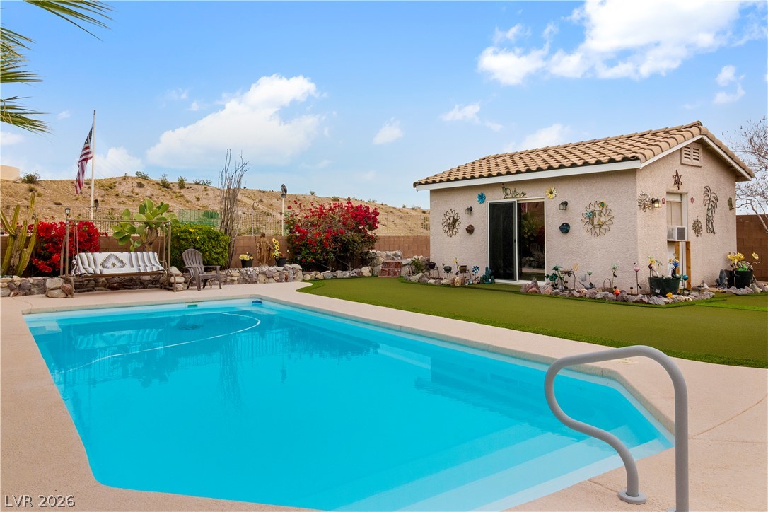 2516 Morrow Ridge Place Laughlin, NV 89029 - Photo 60 of 93 View of pool featuring a fenced backyard, an outdoor structure, and patio surround