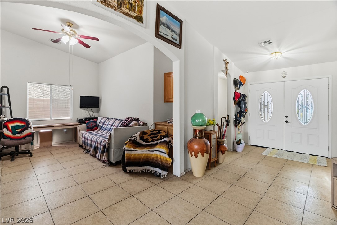 2516 Morrow Ridge Place Laughlin, NV 89029 - Photo 6 of 93 Foyer entrance featuring ceiling fan, vaulted ceiling, light tile patterned floors, and arched walkways