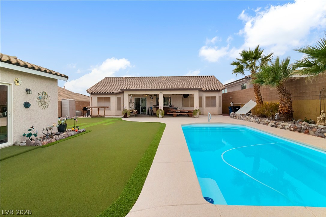 2516 Morrow Ridge Place Laughlin, NV 89029 - Photo 64 of 93 View of pool with patio surround, a fenced backyard, an area to practice putting, and grilling area