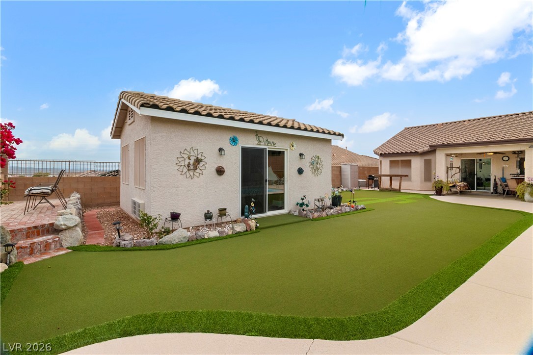 2516 Morrow Ridge Place Laughlin, NV 89029 - Photo 65 of 93 Guest Quarters in Backyard featuring a putting area, a tile roof, stucco siding, and a patio area