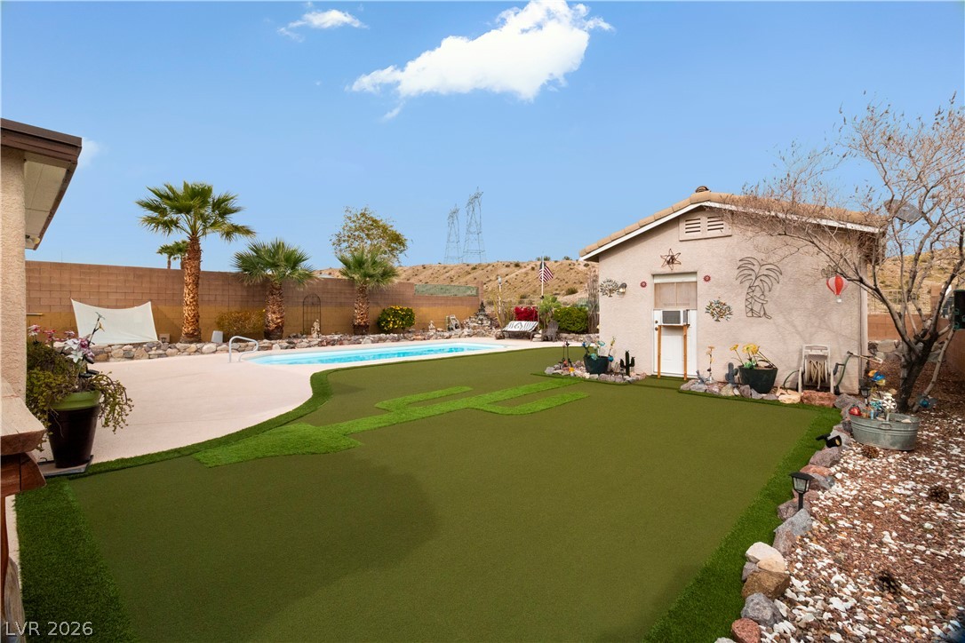 2516 Morrow Ridge Place Laughlin, NV 89029 - Photo 67 of 93 Fenced backyard featuring a putting green and a patio