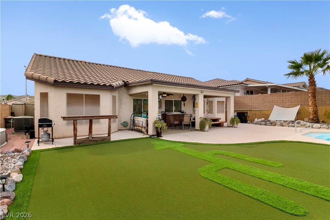2516 Morrow Ridge Place Laughlin, NV 89029 - Photo 68 of 93 Rear view of property with a patio, a ceiling fan, a putting area, and stucco siding