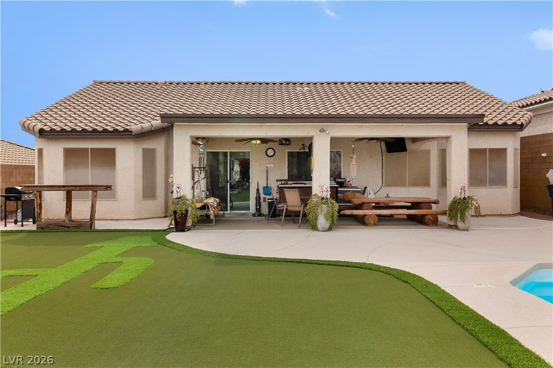2516 Morrow Ridge Place Laughlin, NV 89029 - Photo 69 of 93 Back of house featuring a patio, an area to practice putting, an outdoor pool, and stucco siding