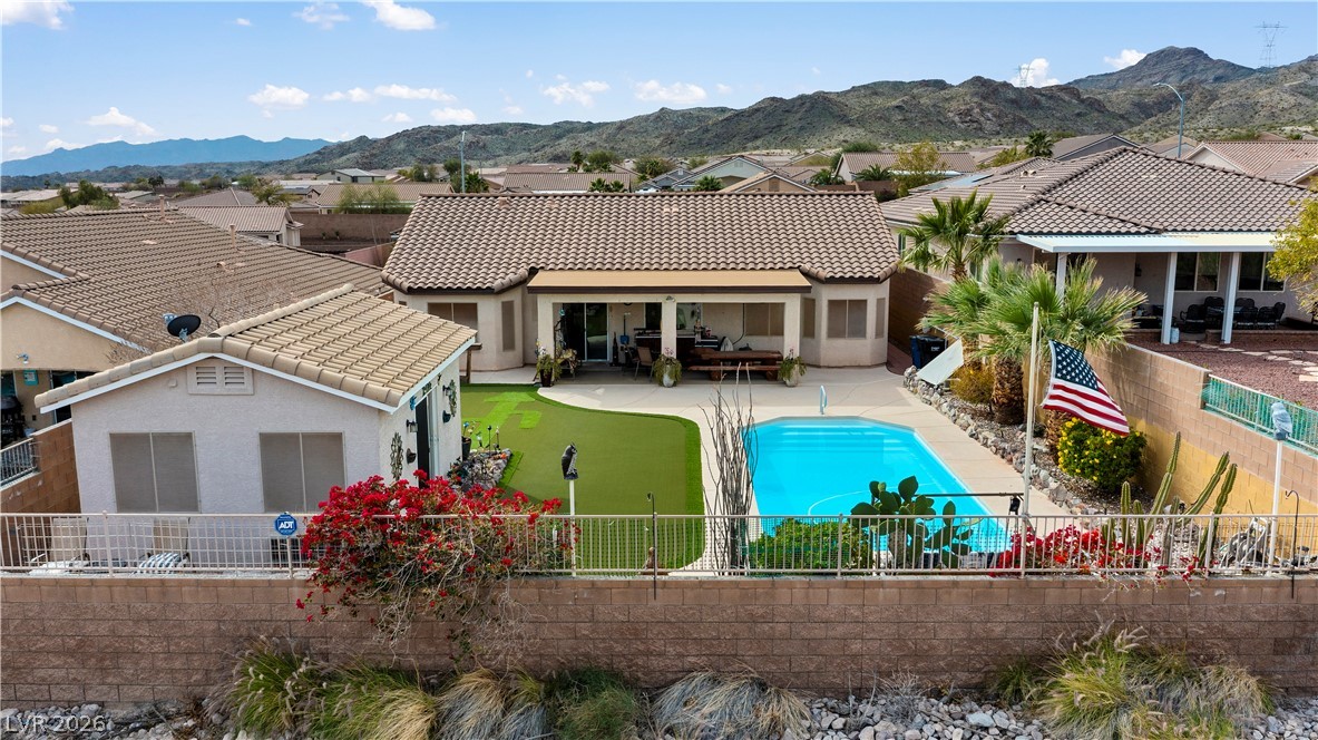 2516 Morrow Ridge Place Laughlin, NV 89029 - Photo 71 of 93 Rear view of property with a mountain view, stucco siding, a fenced backyard, and a patio