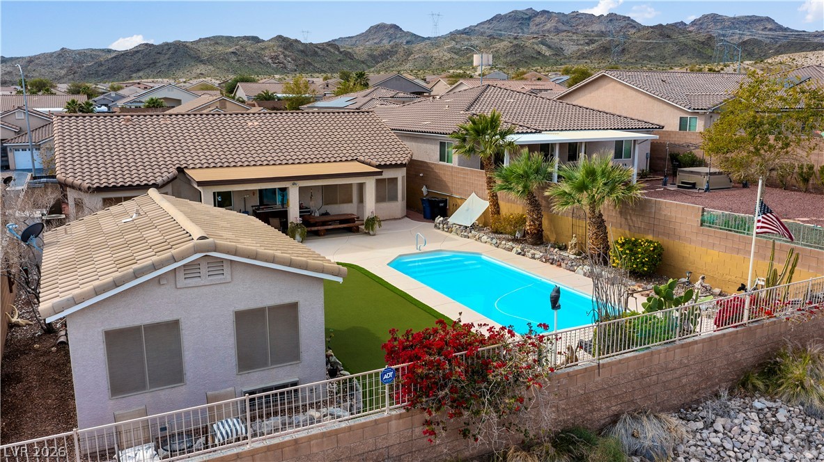 2516 Morrow Ridge Place Laughlin, NV 89029 - Photo 73 of 93 View of swimming pool featuring a fenced backyard, patio surround, a mountain view, and a residential view