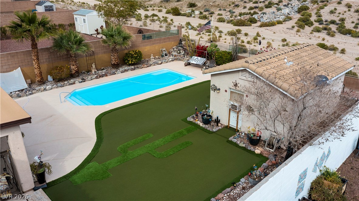 2516 Morrow Ridge Place Laughlin, NV 89029 - Photo 79 of 93 View of pool with patio surround, a fenced backyard, and a storage unit