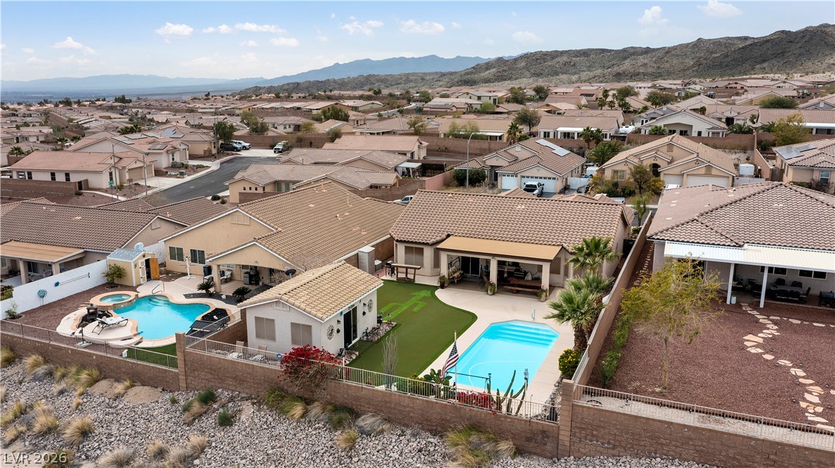 2516 Morrow Ridge Place Laughlin, NV 89029 - Photo 83 of 93 Aerial view of residential area featuring a pool and a mountain backdrop