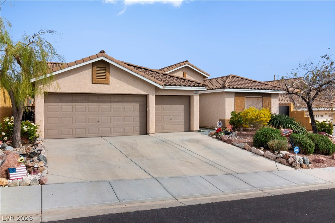 2516 Morrow Ridge Place Laughlin, NV 89029 - Photo 86 of 93 View of front facade with stucco siding, concrete driveway, an attached garage, and a tiled roof