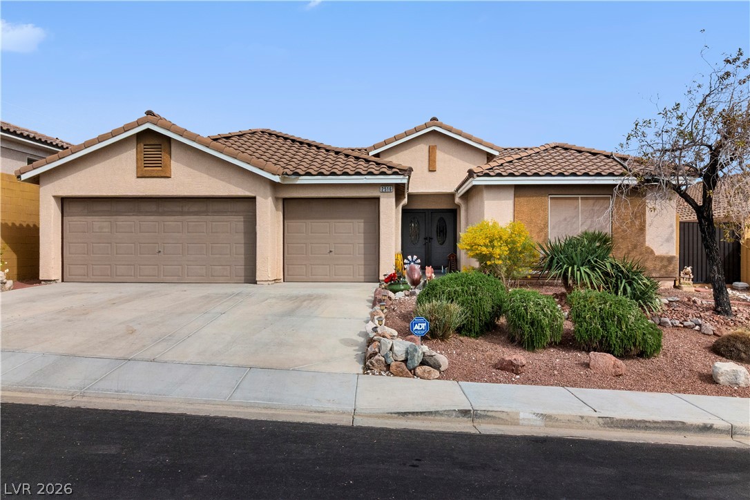 2516 Morrow Ridge Place Laughlin, NV 89029 - Photo 87 of 93 View of front of house with stucco siding, driveway, a garage, and a tile roof