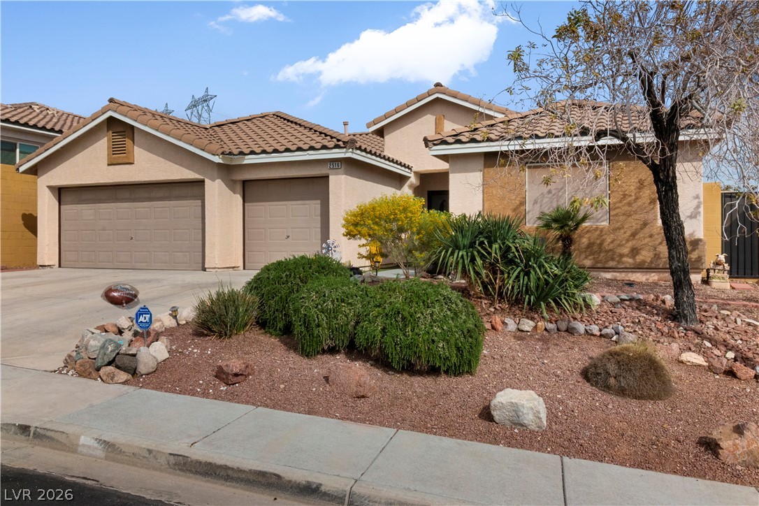 2516 Morrow Ridge Place Laughlin, NV 89029 - Photo 88 of 93 View of front of property featuring stucco siding, driveway, a garage, and a tile roof