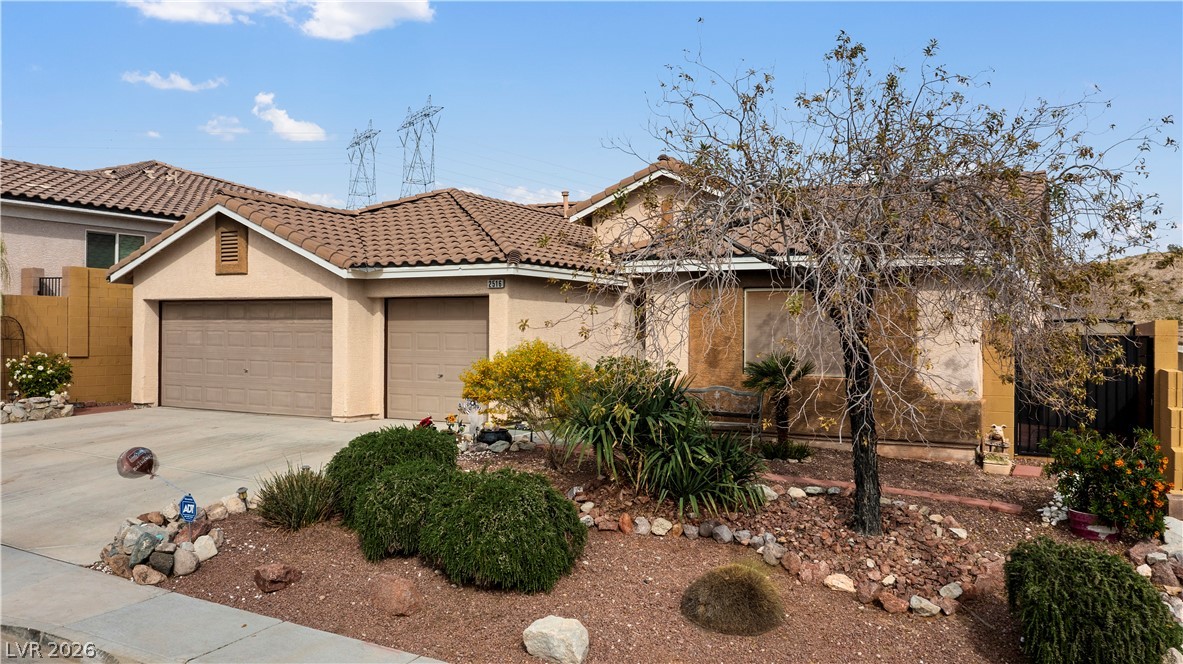 2516 Morrow Ridge Place Laughlin, NV 89029 - Photo 89 of 93 View of front of house featuring an attached garage, stucco siding, driveway, and a tiled roof