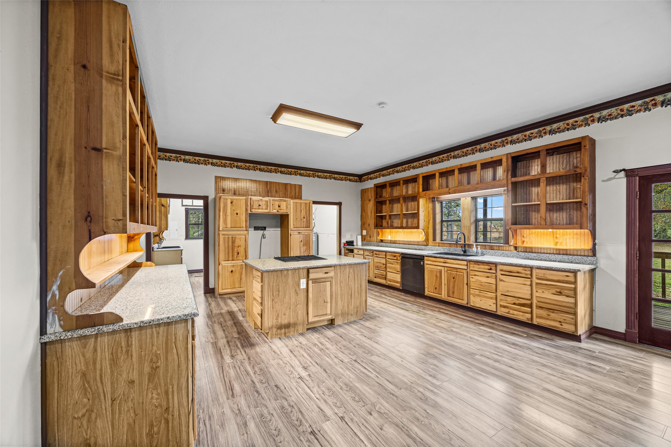 7 Northwood Country Road Huffman, TX 77336 - Photo 16 of 50 a kitchen with stainless steel appliances wooden floor and large windows