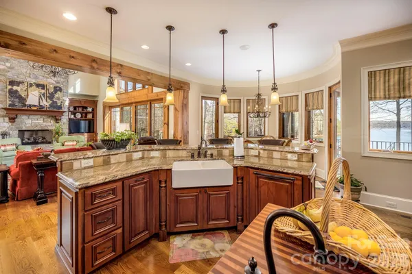 a kitchen with stainless steel appliances granite countertop a stove a sink dishwasher and a wooden cabinets