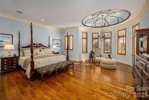 a bedroom with a bed and a chandelier
