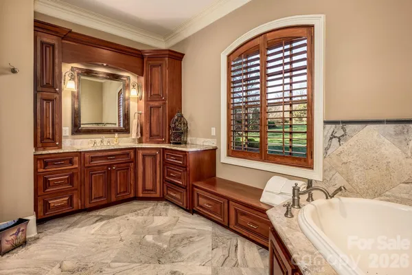 a spacious bathroom with a granite countertop tub sink and mirror