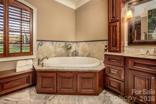 a bathroom with a granite countertop sink and washing machine
