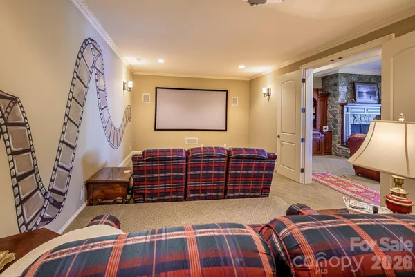 a bedroom with a bed and dresser with the shoe rack