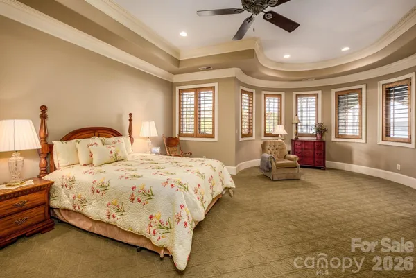 a bedroom with bed and a large window