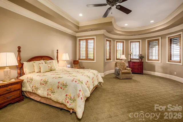 a bedroom with bed and a large window