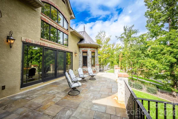 a view of a patio with couches table and chairs and potted plants