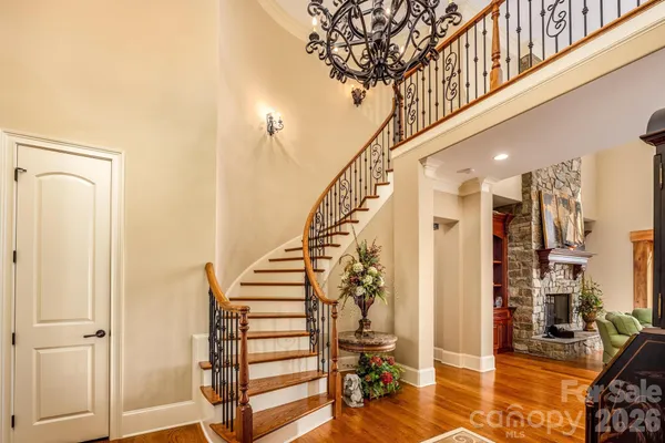 a view of entryway with wooden floor and stairs