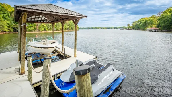 a view of a lake with chairs