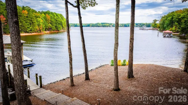 an aerial view of a house with a yard and lake view