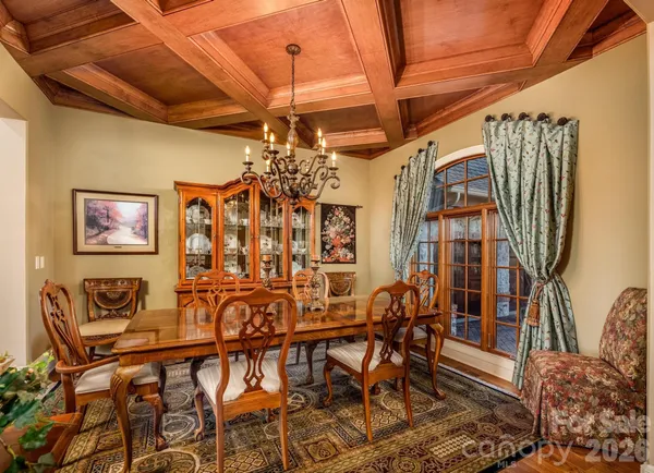 a view of a dining room with furniture and chandelier