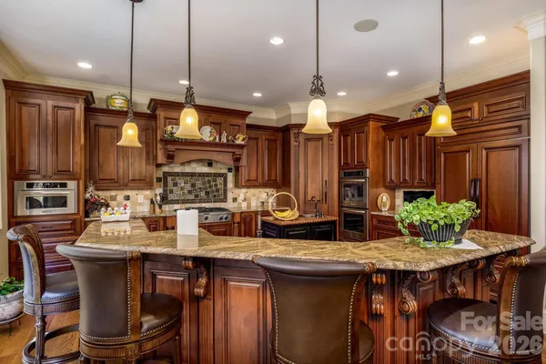 a kitchen with a table chairs sink and stove