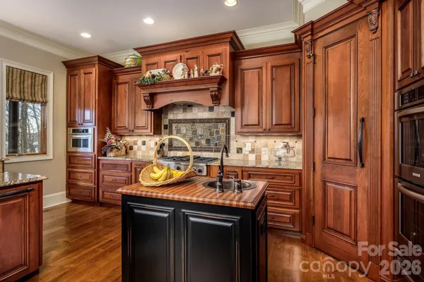 a kitchen with a sink refrigerator and cabinets