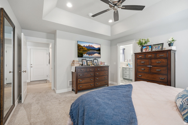 638 Canyon Rim Road Smithfield, UT 84335 - Photo 15 of 56 Bedroom featuring recessed lighting, light carpet, a tray ceiling, ceiling fan, and ensuite bath