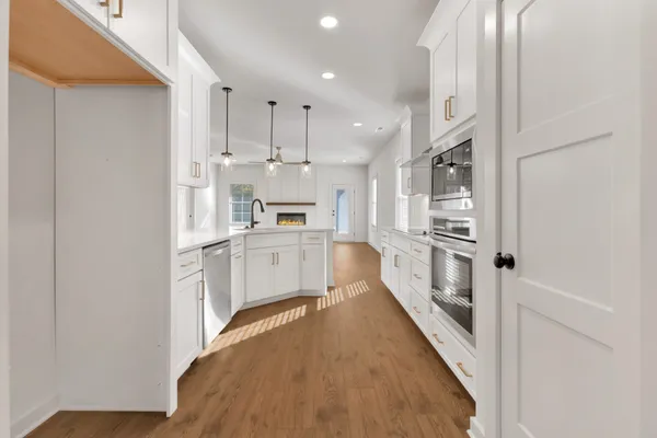 a kitchen with white cabinets and counter top space