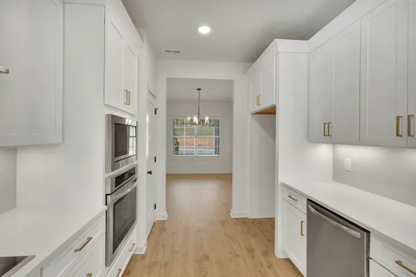 a kitchen with stainless steel appliances a refrigerator and a stove top oven