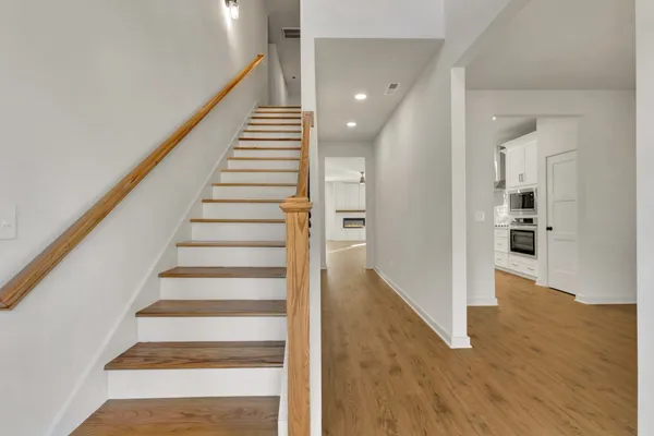 a view of entryway and hall with wooden floor