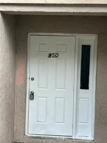 a kitchen with granite countertop a sink cabinets and stainless steel appliances