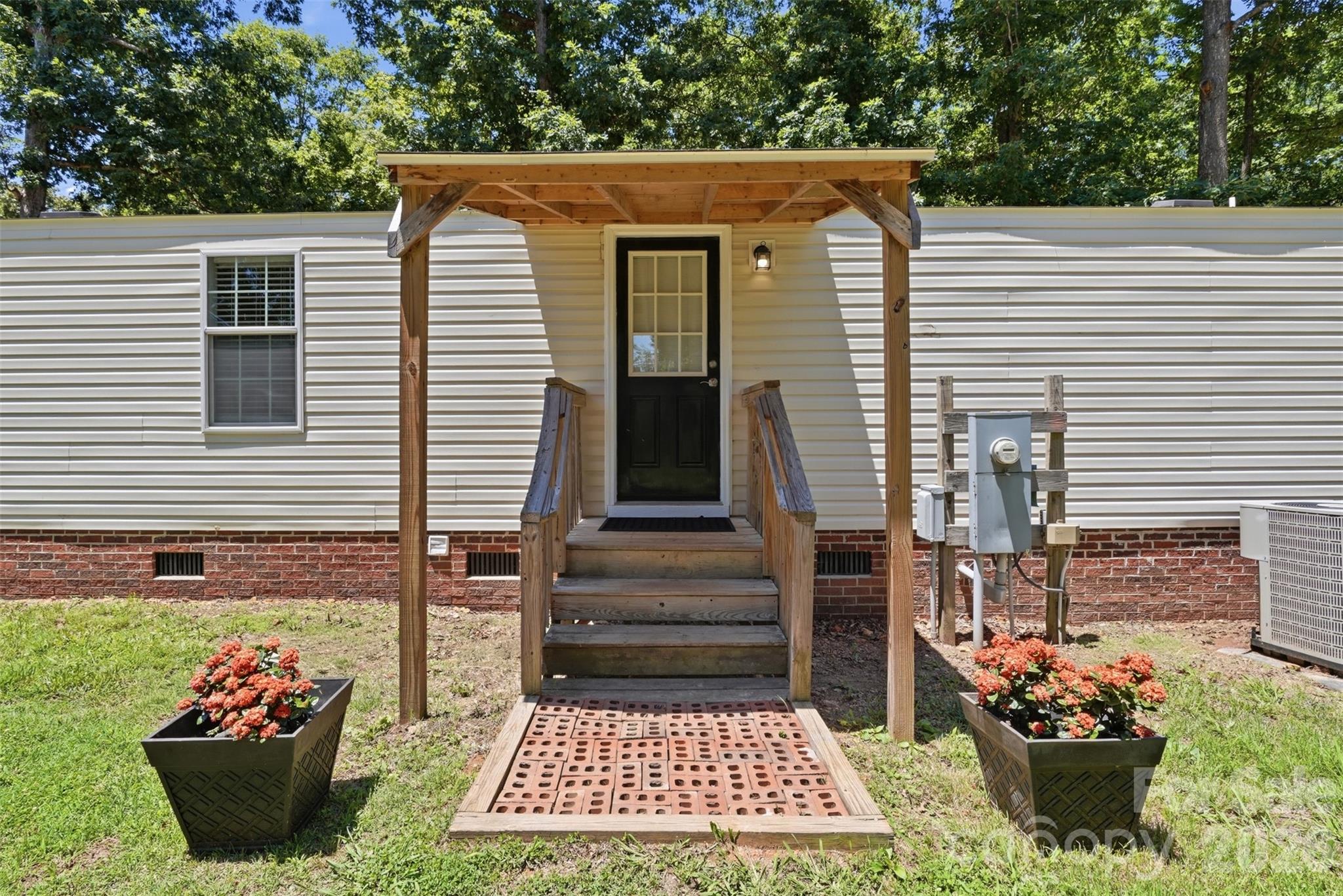 4406 Lucy Short Cut Road Marshville, NC 28103 - Photo 6 of 30 a view of a house with a yard and a garden