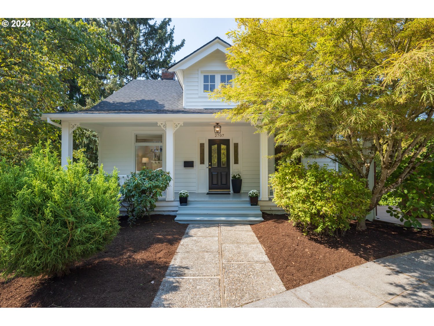 2707 Southwest Homar Avenue Portland, OR 97201 - Photo 1 of 48 a view of a brick house with potted plants