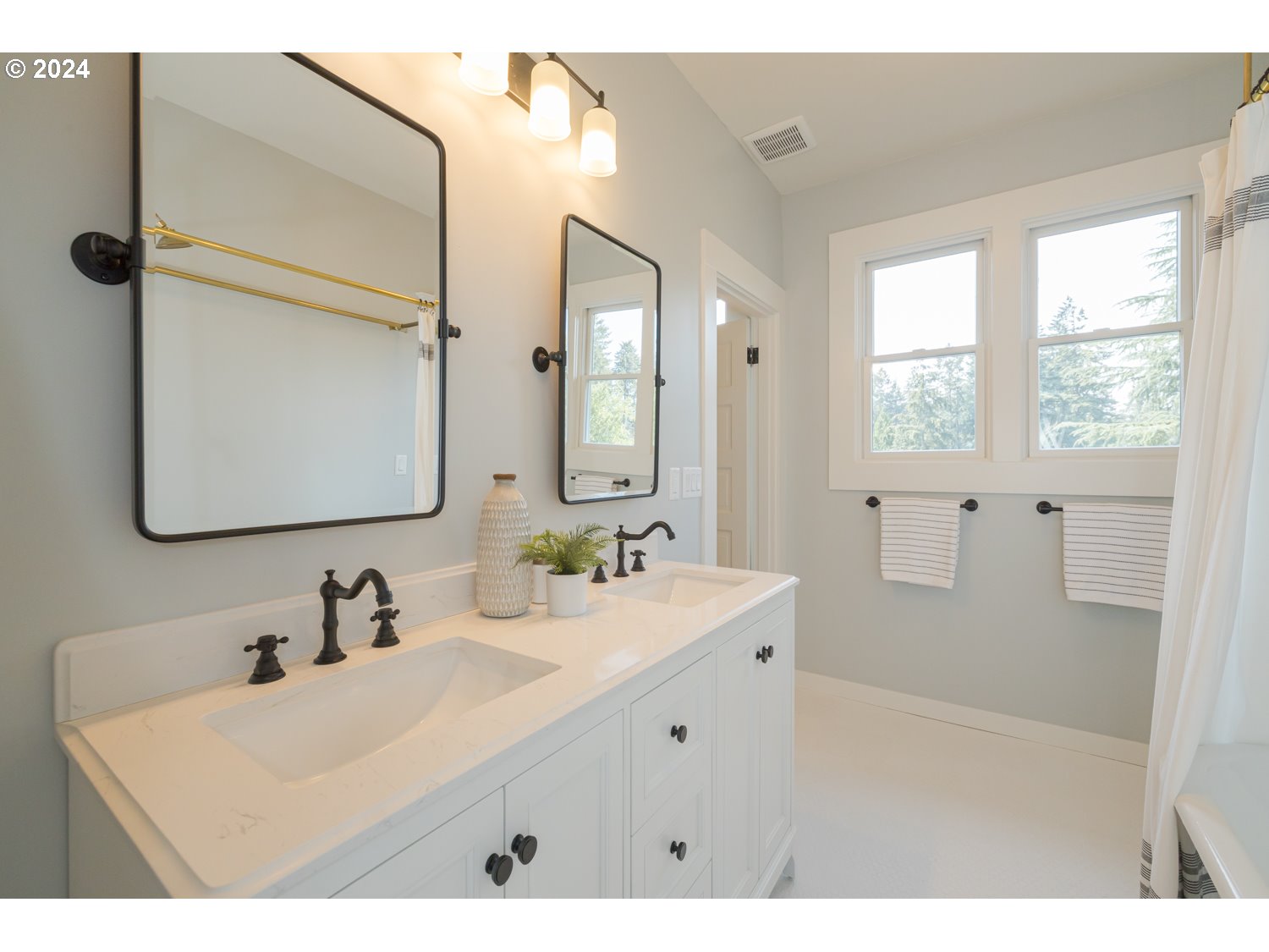 2707 Southwest Homar Avenue Portland, OR 97201 - Photo 13 of 48 a bathroom with a sink vanity granite tub shower and a mirror