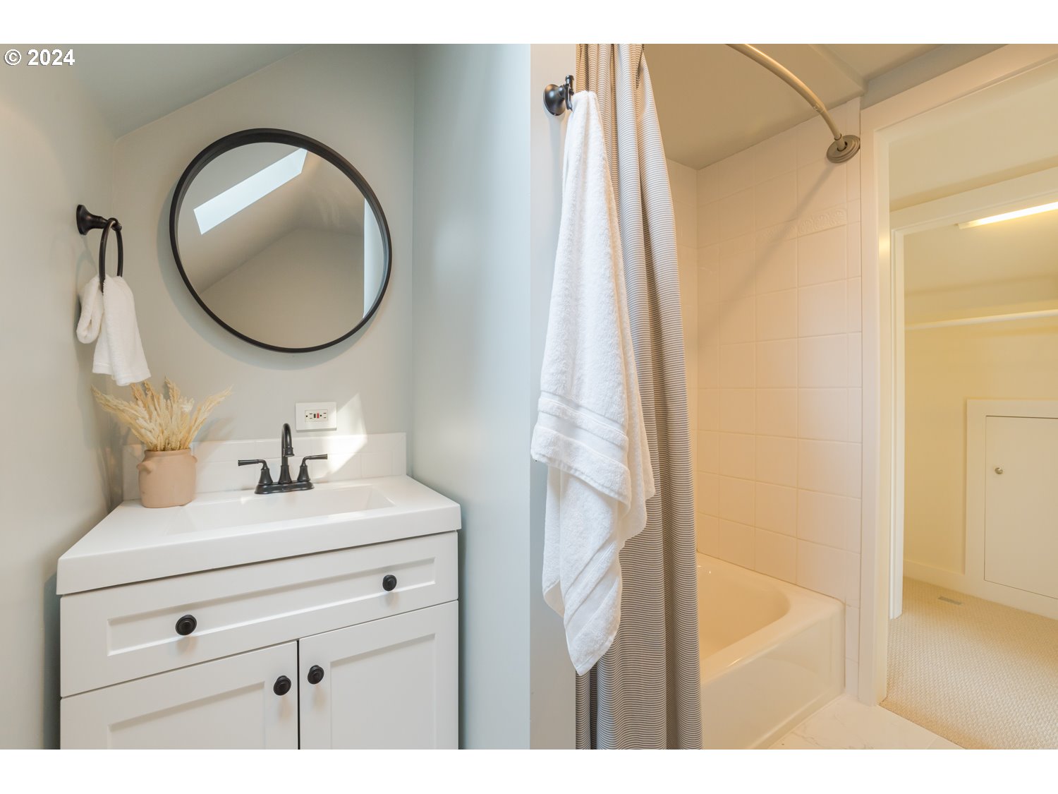 2707 Southwest Homar Avenue Portland, OR 97201 - Photo 25 of 48 a bathroom with a sink mirror and vanity