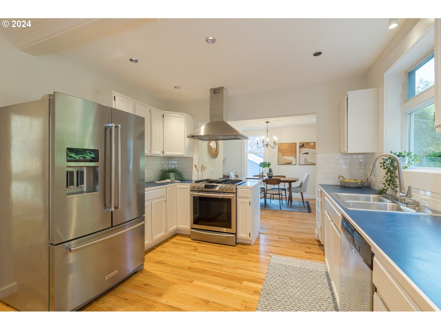 2707 Southwest Homar Avenue Portland, OR 97201 - Photo 43 of 48 a kitchen with stainless steel appliances granite countertop a refrigerator a stove and a sink
