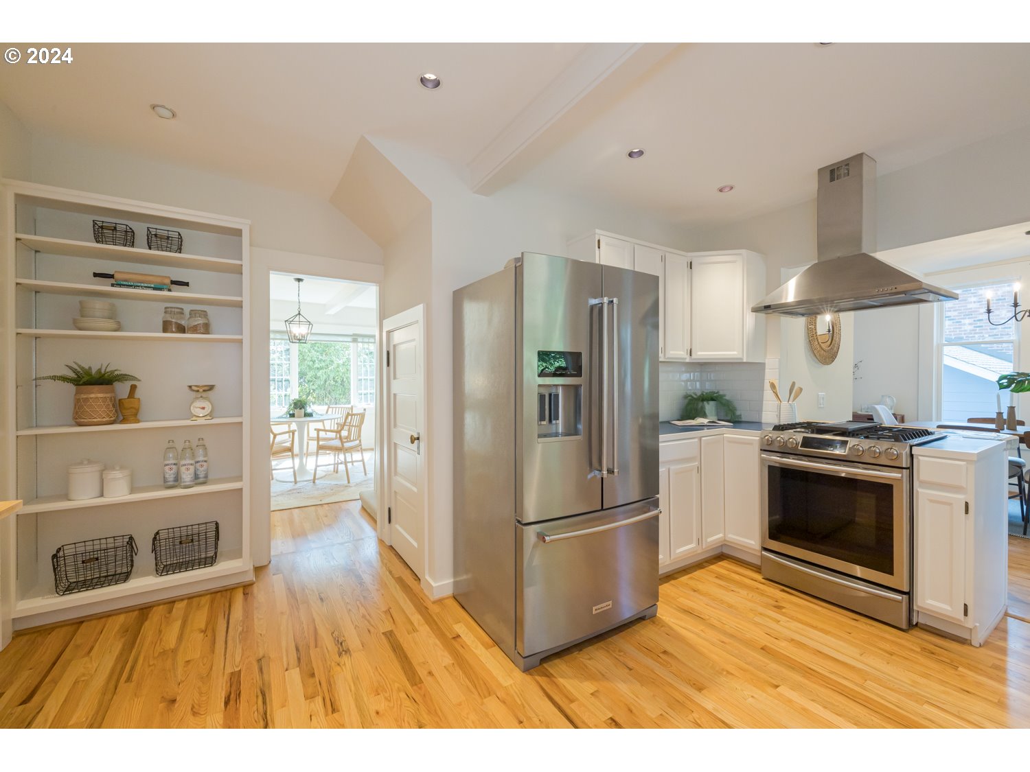 2707 Southwest Homar Avenue Portland, OR 97201 - Photo 44 of 48 a kitchen with stainless steel appliances granite countertop a refrigerator a stove a sink and a wooden floors
