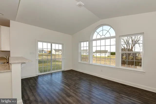 an empty room with a empty space and windows