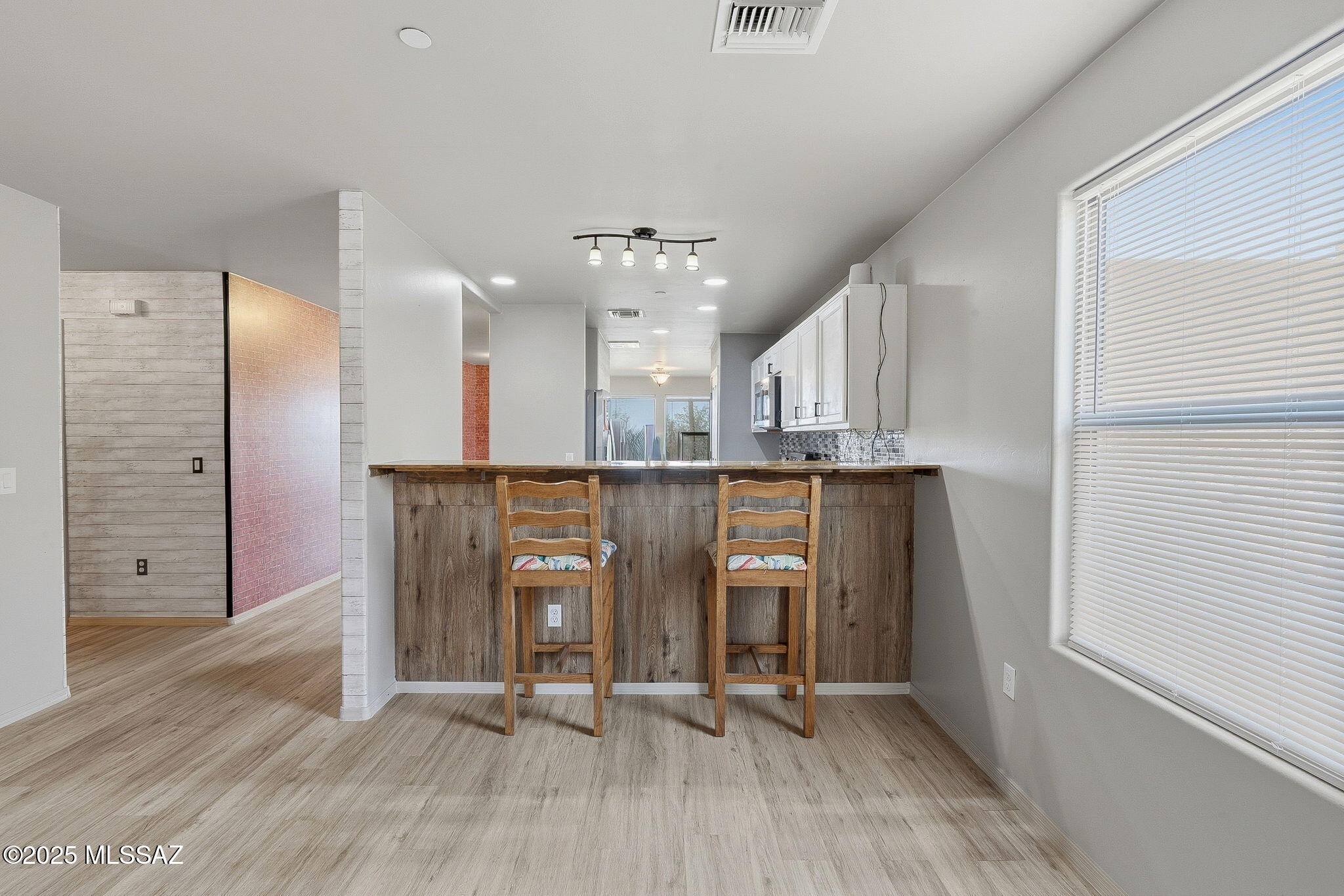 1458 North Wentworth Road Vail, AZ 85641 - Photo 31 of 44 an empty room with wooden floor and windows