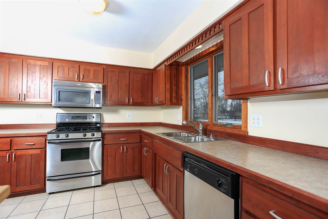 4010 North Meridian Road Rockford, IL 61101 - Photo 3 of 25 a kitchen with stainless steel appliances granite countertop a sink stove and cabinets