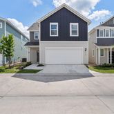 an aerial view of a house with garden space and street view